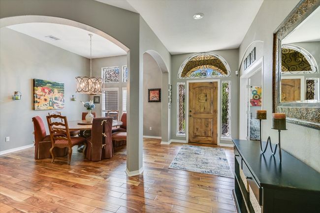 Foyer entrance with arched walkways, light wood-type flooring, baseboards, a chandelier, and recessed lighting | Image 6