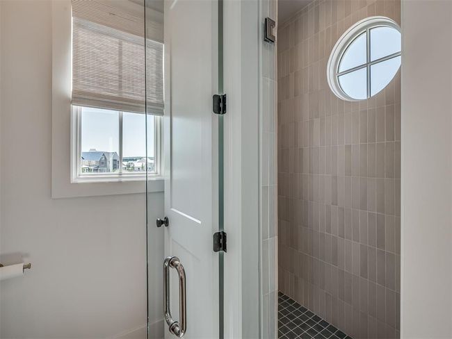 Bathroom featuring healthy amount of natural light and a tile shower | Image 25