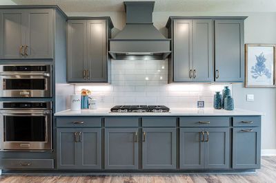 This kitchen is a showstopper! Anchored by a huge, angled center island, with a stunning collection of stainless steel appliances, plus a butler's pantry! | Image 3