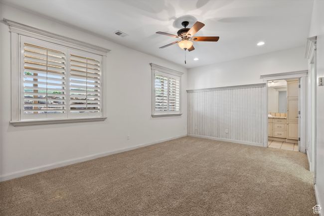 Unfurnished bedroom featuring light colored carpet, recessed lighting, baseboards, connected bathroom, and a ceiling fan | Image 50