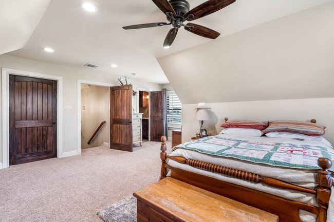 Bedroom featuring light colored carpet, recessed lighting, lofted ceiling, and ceiling fan | Image 30
