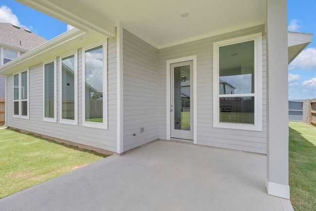 This covered patio isn’t just an extension of your home; it’s a place where you can truly connect with nature and the people you love. | Image 22