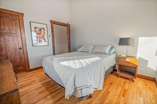 Bedroom with light wood-type flooring and baseboards | Image 18