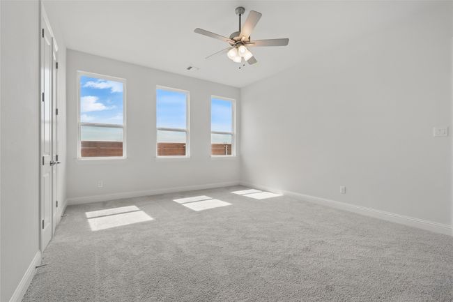 Carpeted spare room with a ceiling fan, baseboards, and visible vents | Image 18