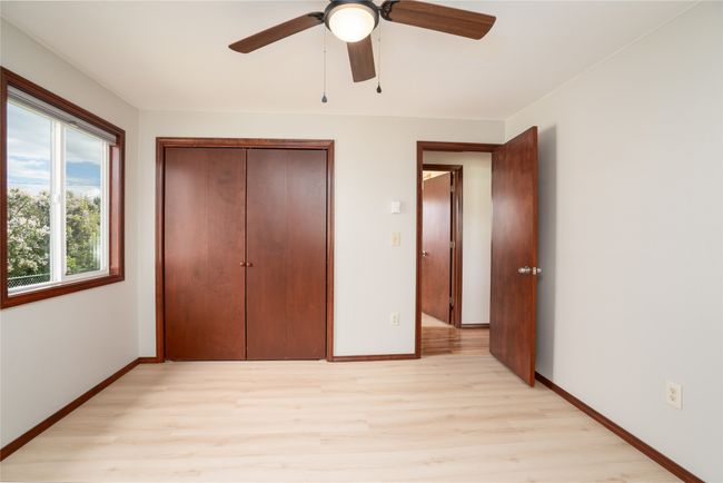 Unfurnished bedroom with light wood-style floors, baseboards, a closet, and ceiling fan | Image 14