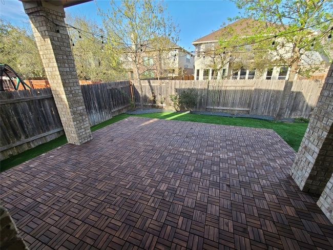 Fenced backyard with a patio | Image 32