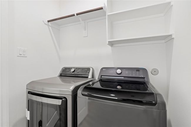 This utility room is equipped with built in shelving and a place to hang items while you work. | Image 28