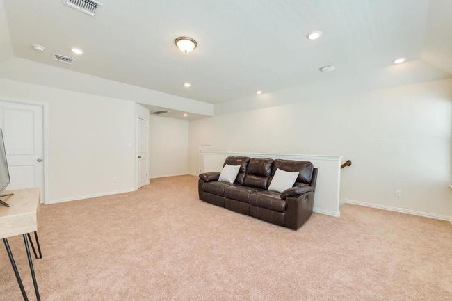 Living room with light colored carpet, recessed lighting, and baseboards | Image 29