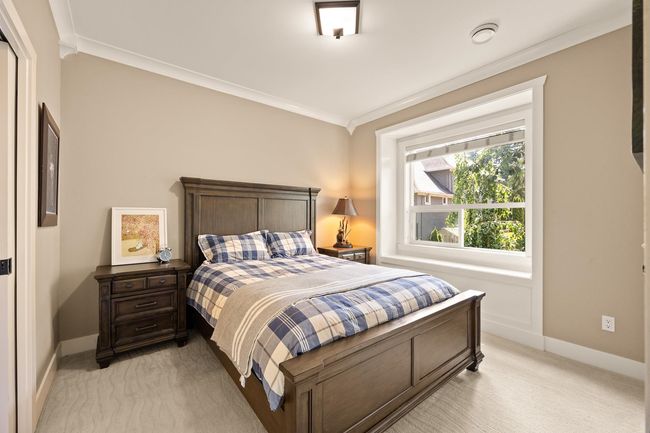 Bedroom with light colored carpet and ornamental molding | Image 16