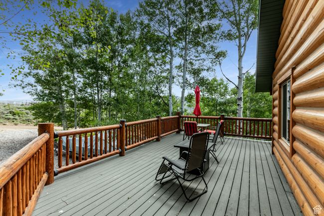 Wooden deck featuring outdoor dining area | Image 4