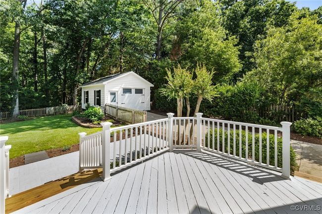 View from deck looking into rear yard and one-car garage with pedestrian door. | Image 36