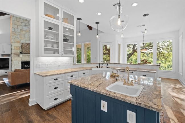 Kitchen featuring glass insert cabinets, dark wood-style floors, and a sink | Image 12