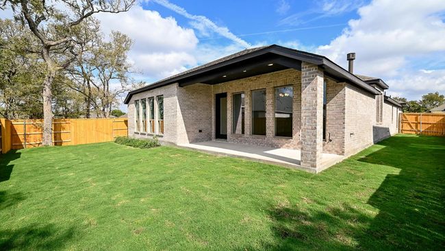 Back of house with a fenced backyard, a patio area, and brick siding | Image 23