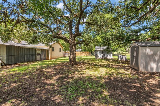 View of yard with a storage shed | Image 30