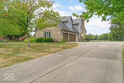 Three-car garage with aggregate driveway! | Image 2