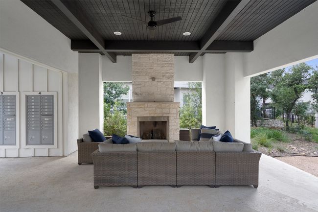 View of patio / terrace with an outdoor living space with a fireplace, mail area, and a ceiling fan | Image 7