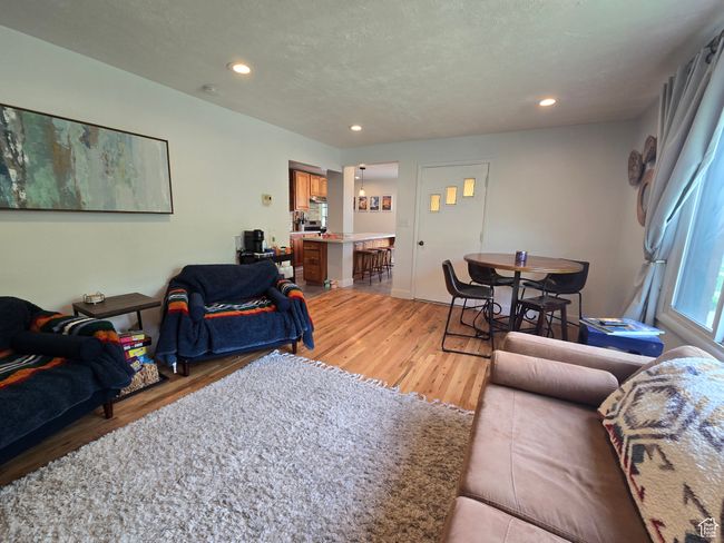 Living room featuring light wood finished floors and recessed lighting | Image 15