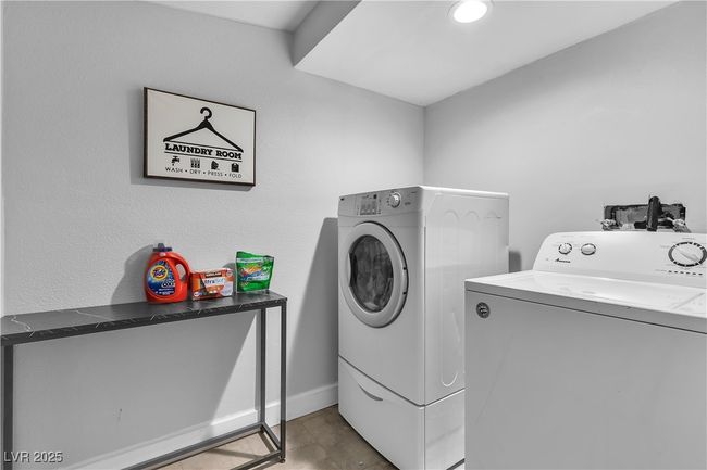 Laundry area featuring baseboards, laundry area, and washer and clothes dryer | Image 23