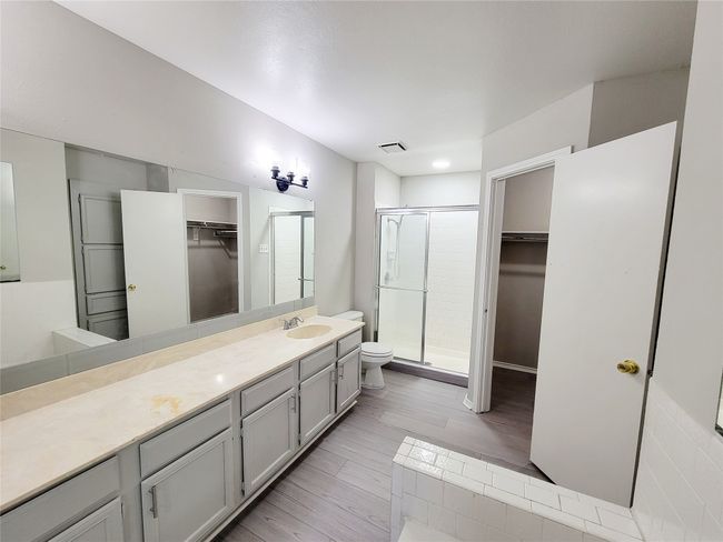 Bathroom with vanity, toilet, and an enclosed shower | Image 14