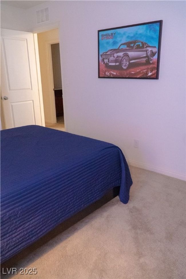 Carpeted bedroom with visible vents and baseboards | Image 52