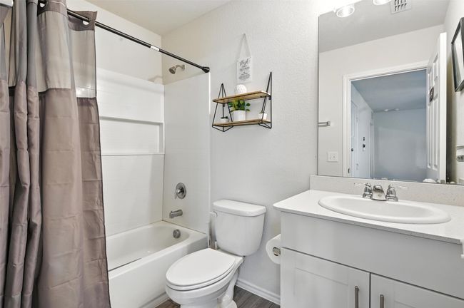 Full bathroom featuring shower / bath combination with curtain and vanity | Image 21