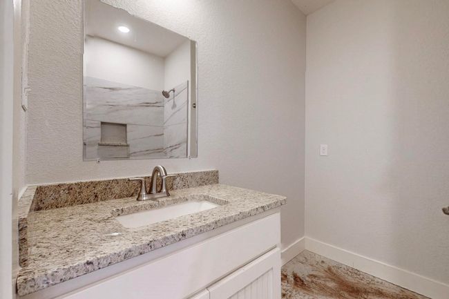 Bathroom with a marble finish shower, baseboards, and vanity | Image 20
