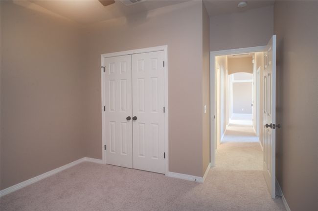 Unfurnished bedroom featuring light carpet, a closet, and baseboards | Image 14
