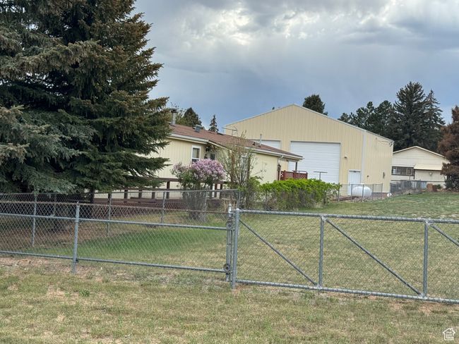 View of side of home with a gate | Image 4