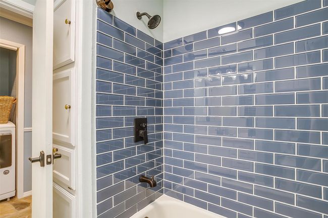 Bathroom with shower / bath combination and washer / clothes dryer | Image 27