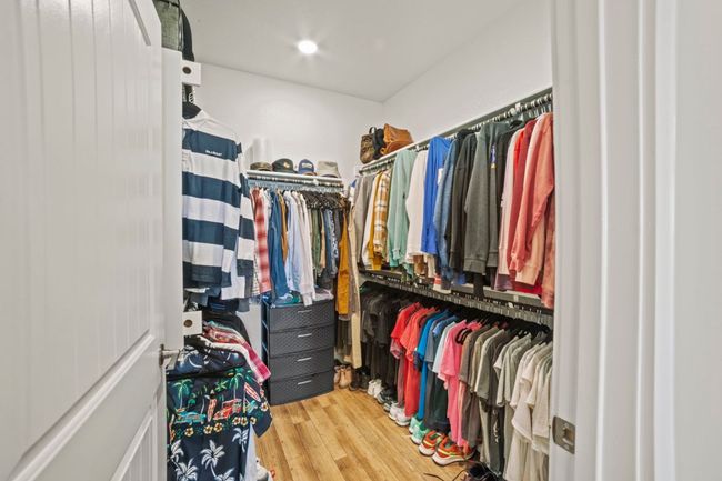 Spacious closet with wood finished floors | Image 26