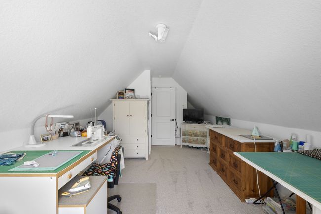 Home office featuring light colored carpet, vaulted ceiling, and a textured ceiling | Image 29