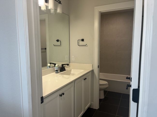 Bathroom featuring toilet, tile patterned flooring, and vanity | Image 28