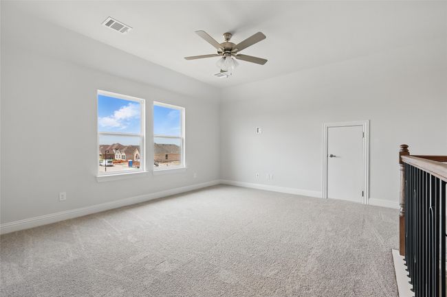 Carpeted empty room featuring baseboards, visible vents, and a ceiling fan | Image 24