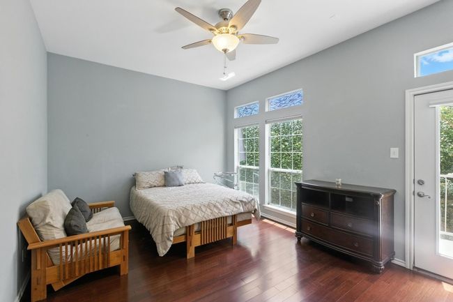 Bedroom featuring wood finished floors, access to outside, and ceiling fan | Image 21