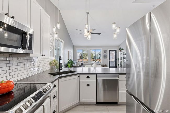 stainless steel appliances, quartz counters, tons of light and a breakfast bar | Image 7