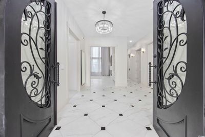 Entrance foyer with a notable chandelier | Image 2