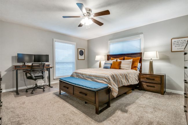 Bedroom featuring ceiling fan, multiple windows, and carpet floors | Image 14