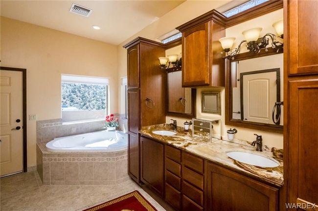 Bathroom featuring a garden tub, tile patterned floors, and double vanity | Image 49