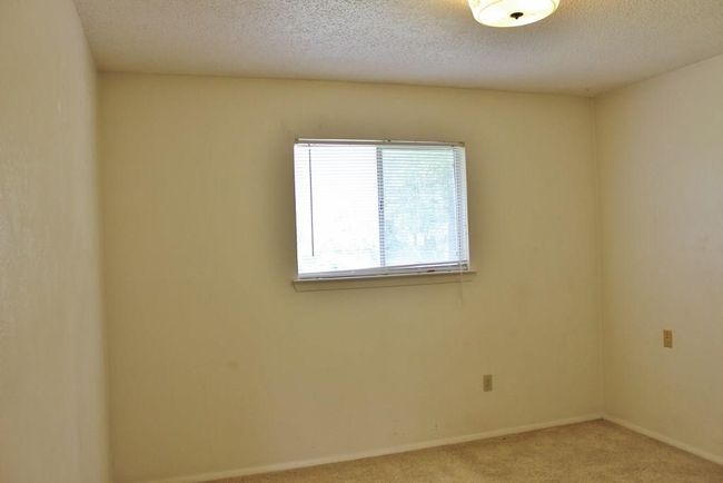 Empty room featuring light carpet and a textured ceiling | Image 5