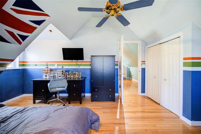 Bedroom 3 featuring wood-type flooring, lofted ceiling, a closet, and baseboards | Image 31
