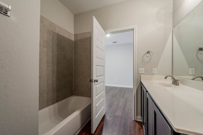 Full bath featuring vanity, wood finished floors, and visible vents | Image 30