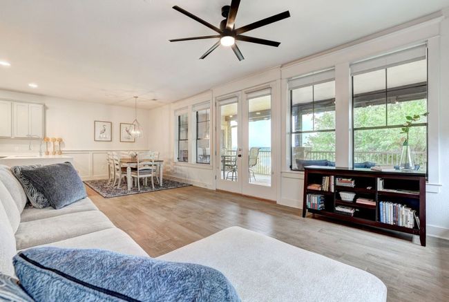 Living area featuring wood finished floors, a ceiling fan, french doors, a chandelier, and recessed lighting | Image 14