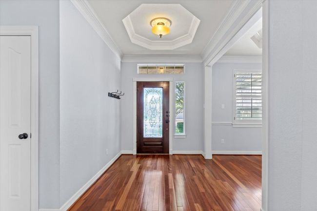 The foyer's high tray ceilings, create a sophisticated first impression. | Image 8