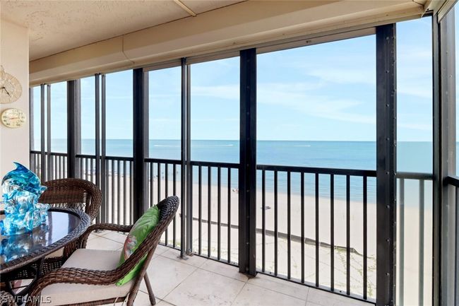 Sunroom / solarium featuring a water view and a beach view | Image 26