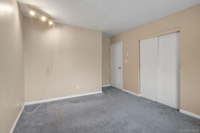 Unfurnished bedroom featuring a closet, baseboards, and carpet | Image 21