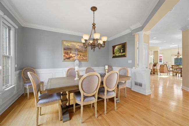 The dining room is complimented by wainscoting and dentil crown molding. | Image 7
