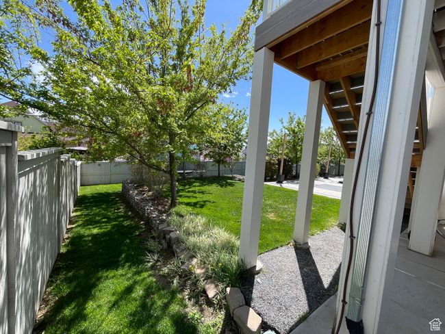 View of yard featuring a fenced backyard with mature fruit trees | Image 70