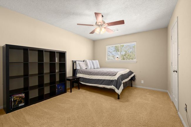 Bedroom 2 - Ceiling fan, neutral paint, walk-in closet, 2" blinds and has an entrance to Bath #2 with a private sink/vanity. | Image 26