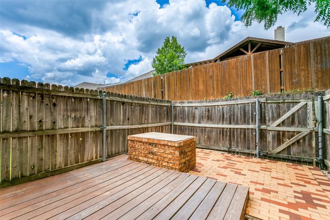 Deck with a fenced backyard and a patio area | Image 23