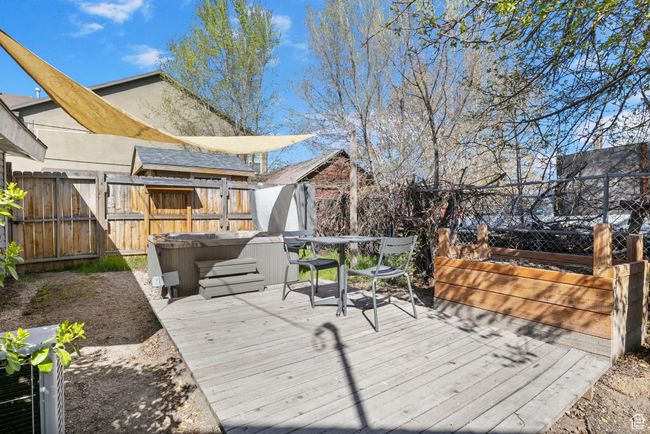Wooden deck with fence and a hot tub | Image 50